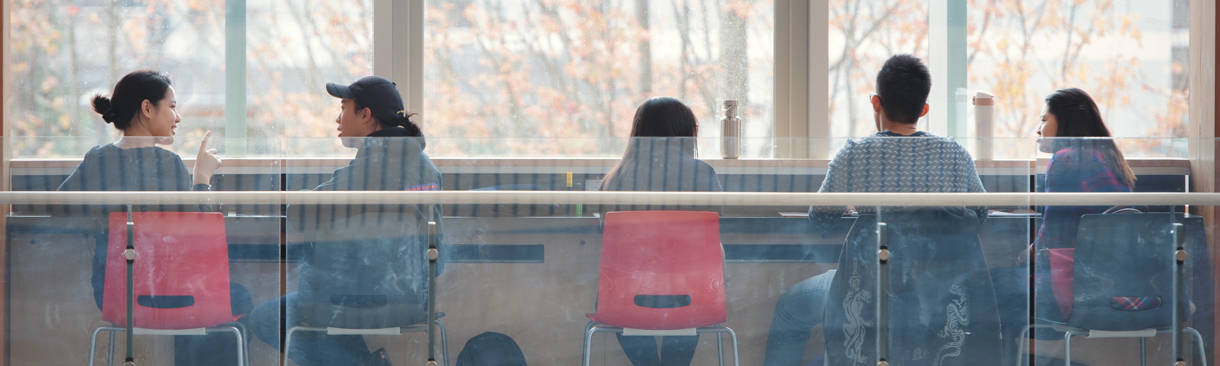 Students sitting in the Nest, chatting and studying