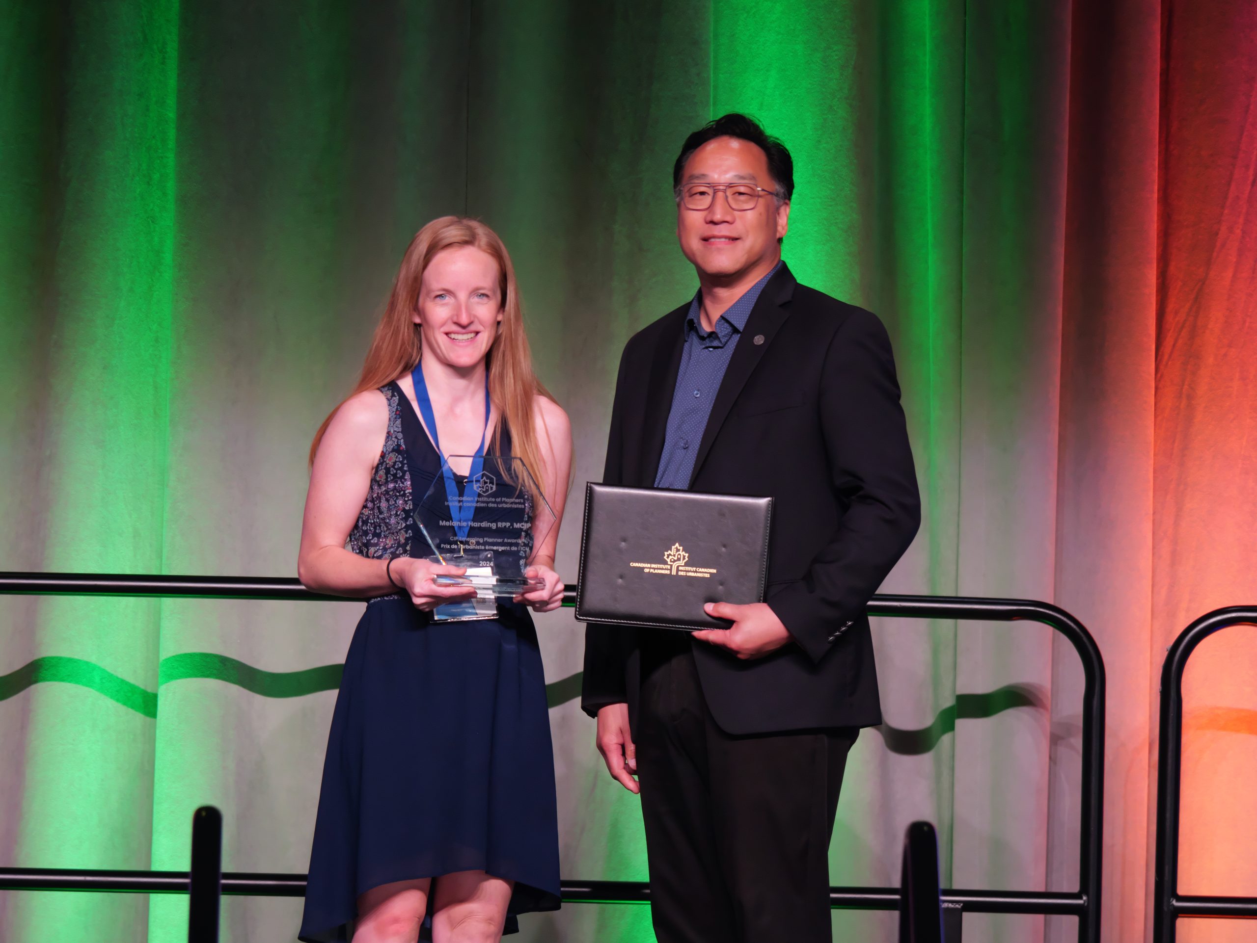 Young woman receives award on stage