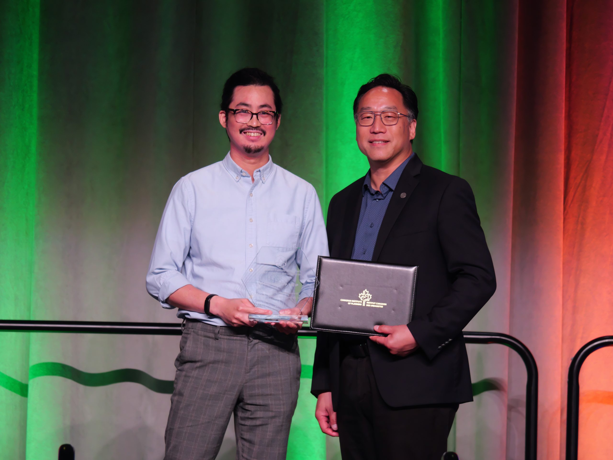 Young man receives an award on stage