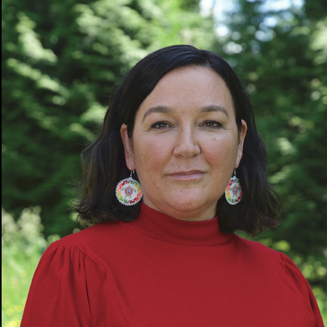 Woman in red shirt among trees