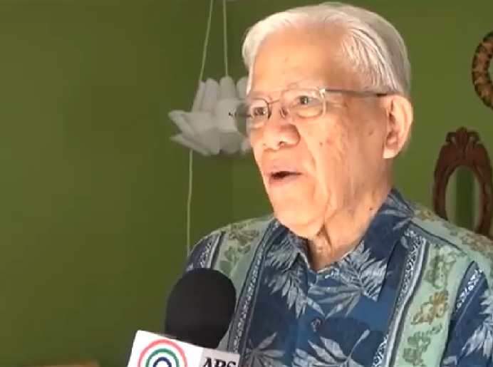 Man speaking into news mic