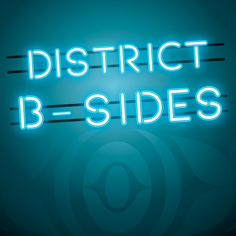 "District B-Sides" logo, written in turquoise neon lightbulb with the Squamish logo