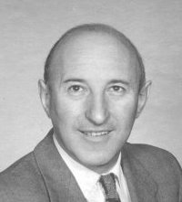 Black-and-white photograph of man in suit and tie