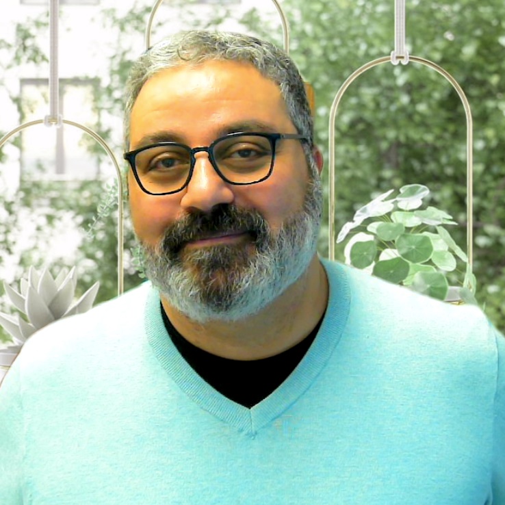 Man in white sweater in garden