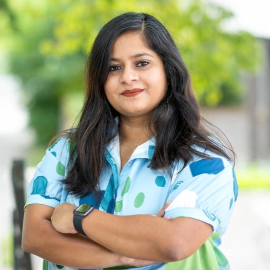 Woman with arms folded in polkadot top