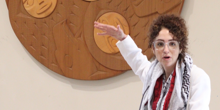 Student presenting at a Musqueam symbol