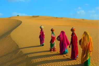 Women in desert with pots on their heads