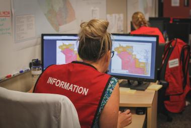 Emergency response crew team member pores over wildfire data