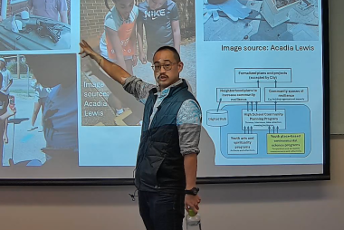 Man pointing at projected presentation and talking