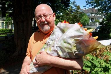 Older man holding bouquet of flowers