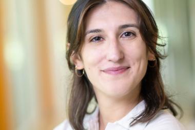 A woman in a white button-up shirt