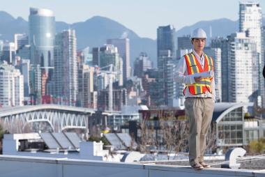 Man in construction gear atop a Vancouver scaffold