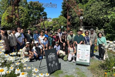 A crowd of students posing together in a UBC garden