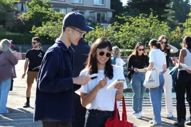 A crowd of students socialising in the sun