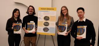 Four students presenting their project poster