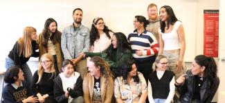 Students clustered in a pose during a shared joke