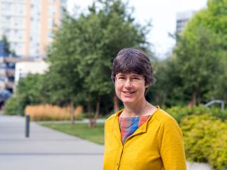Heather, in yellow jumper among trees