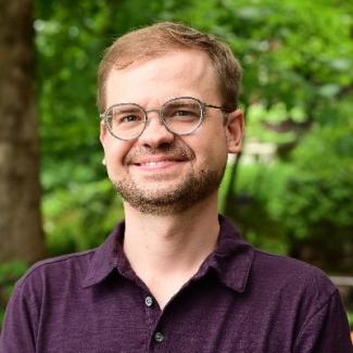 man with glasses, among trees