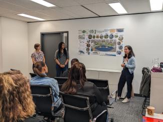 SCARP student presenting poster to small room