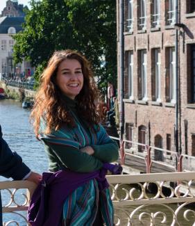 Woman posing on bridge above European river