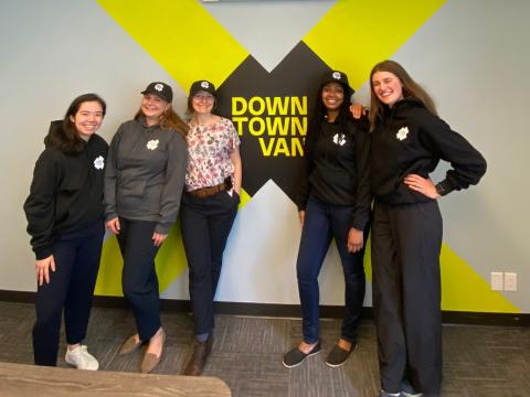 5 SCARP students leaning against a Downtown Van logo