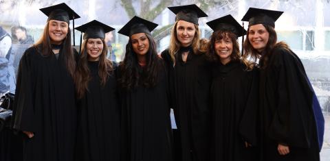 SCARP grads in regalia, arm-in-arm