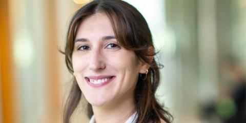 Woman smiling in white button-up shirt