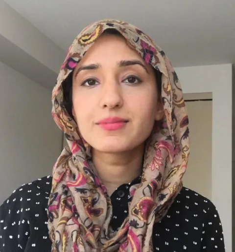 Woman in polkadot top and headdress