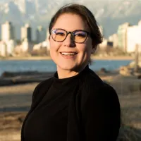 Rebecca, in Vancouver area with shoreline, cityscape, and mountain range