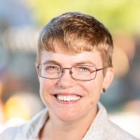 Woman in glasses, smiling
