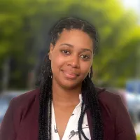 Profile of woman in blazer, among trees