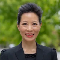 Su-Jan, in black blazer among trees