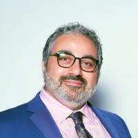Maged, in blue suit and paisley tie