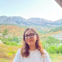 Woman in valley surrounded by mountains