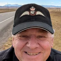 Man in cap with symbol of wings and crown