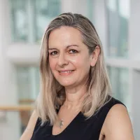 Woman with tall building in background